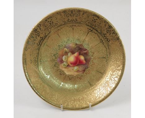 A Royal Worcester cabinet plate, decorated with a central panel of hand painted fruit by Price, to a deep acid gilt border, d