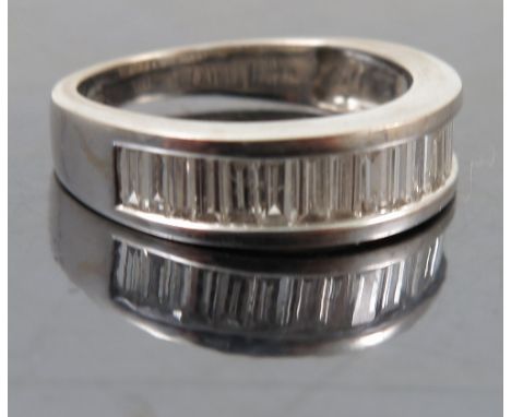 An 18ct white gold diamond half hoop ring, the nineteen baguettes totalling approximately 0.7cts, finger size M, weight 4.9g 