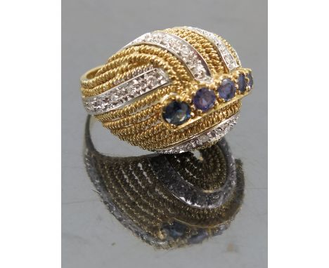 A sapphire and diamond bombe dress ring, circa 1960's, set with a central line of sapphires and lines of single cut diamonds 