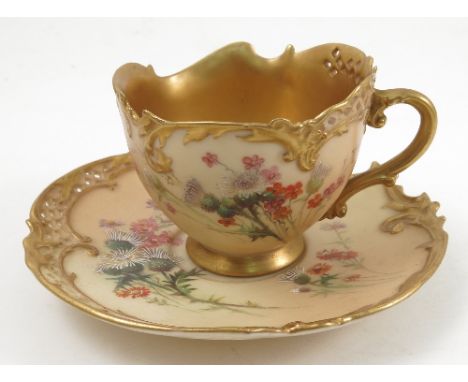 A Royal Worcester cup and saucer, the cup decorated with floral sprays, the saucer being similarly decorated to a shaped and 