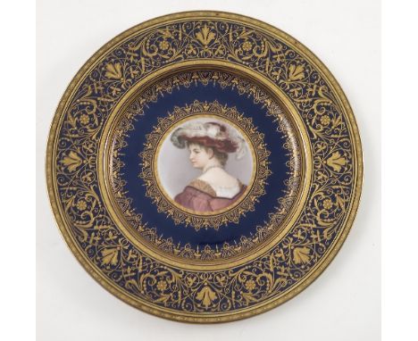 A late 19th/early 20th Viennese plate, decorated with a bust portrait of a young girl looking over her shoulder, to a blue gr