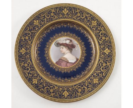 A late 19th/early 20th Viennese plate, decorated with a bust portrait of a young girl looking over her shoulder, to a blue gr