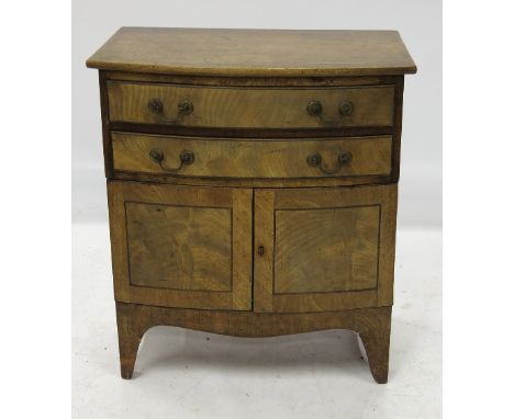 A late 19th mahogany commode, having bow front outline over two cupboards, width 24ins