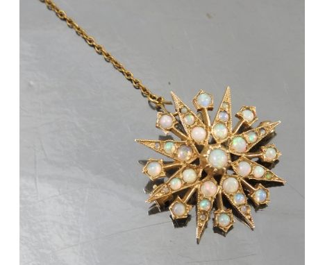 An opal star burst brooch pendant, in 9ct gold, London 1973, diameter 2.8cm, weight 4.8g gross