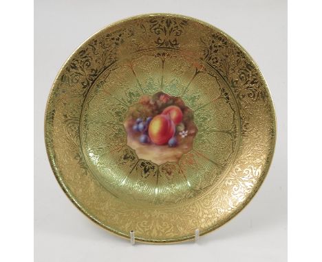 A Royal Worcester cabinet plate, decorated with a central panel of hand painted fruit by Price, to a deep acid gilt border, d