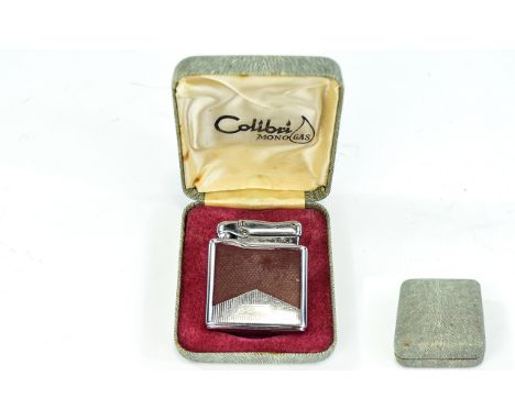 Vintage Boxed Colibri Mono Gas Lighter Silver tone metal with textured claret panels to front and back. Impressed Colibri bra
