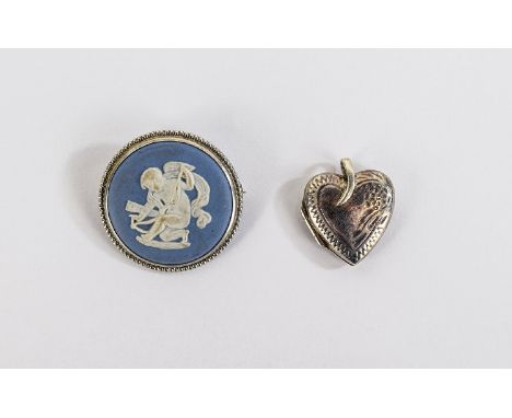 Wedgwood Pale Blue Jasper Brooch, a roundel showing Cupid preparing his bow, in white on the pale blue ground, impressed Wedg