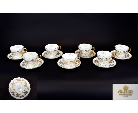 Coalport Bone China Cups And Saucers Seven in total, cream ground with gilt bird and floral pattern