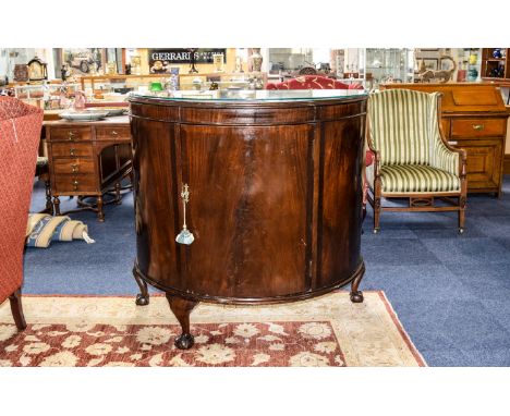 Drinks Cabinet Large dark wood crescent shaped cabinet with curved front and lockable door with claw ball feet. One leg missi