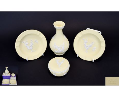 Small Collection Of Wedgwood Jasperware Four items in total in primrose yellow with white Japonica decoration, to include two