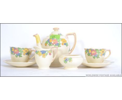 A pretty vintage 1930's Royal Doulton chintzy breakfast tea set. Consisting of a pair of trio's, teapot, creamer and sugar bo