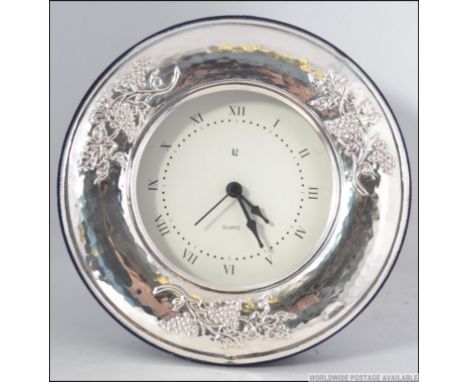 A silver 925 easel backed circular mantel clock being stamped 925 to the surround with quartz movement. Measures: 15cms 