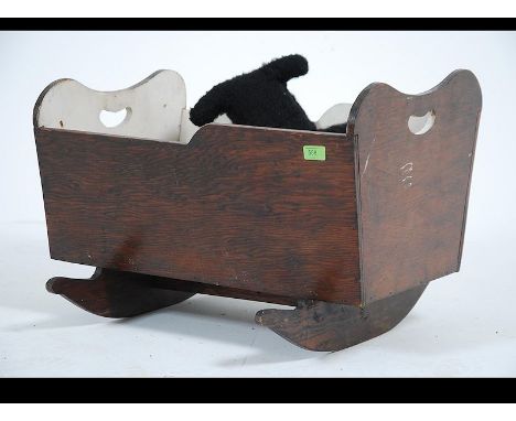 A vintage early 20th century childs crib having painted interior together with a collection of assorted teddy bears etc