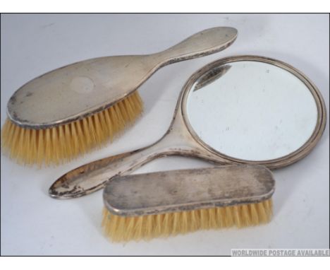 A group of three silver hallmarked dressing table brush set, having engine turned geometric design. Birmingham assay mark, da