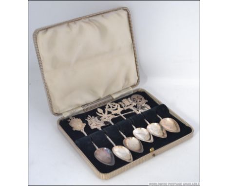 A collection of seven silver early 20th century teaspoons. Each spoon having a different Malaysian state and coat of arms to 