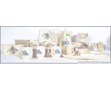 A retro chintzy part tea service by SylvaC, to include plates, cups, bowls, butter dish, coffee pot, creamers, cheese dish et