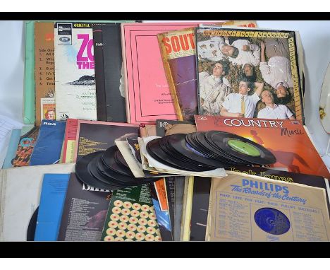 A collection of vintage vinyl Long Play records along with some 45rpm to include various artists and genres.
