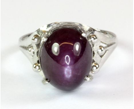 A platinum (stamped 850) ring set with a cabochon cut star ruby, (N).