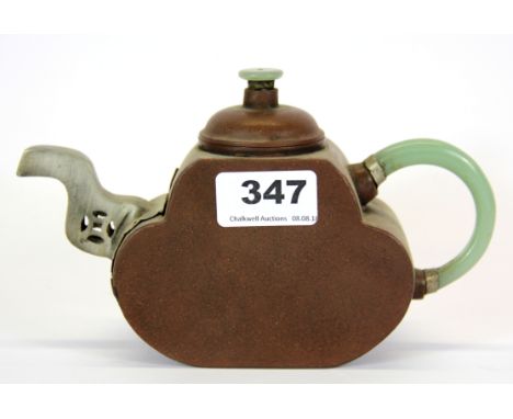 A Chinese Yixing terracotta teapot with pewter spout and jade handle.
