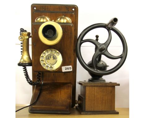 A reproduction wood and brass telephone and coffee grinder.