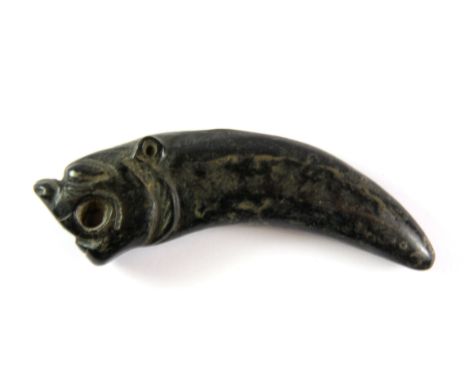 An early Japanese carved stone tigers head and claw netsuke, L. 10cm.