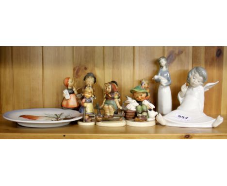 A small group of Hummel figures together with a Lladro angel and girl.