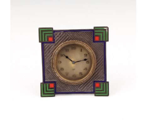 An Art Deco silver and enamel surround desk clock, of geometric design highlighted in green, blue and red enamel, clock of 8 