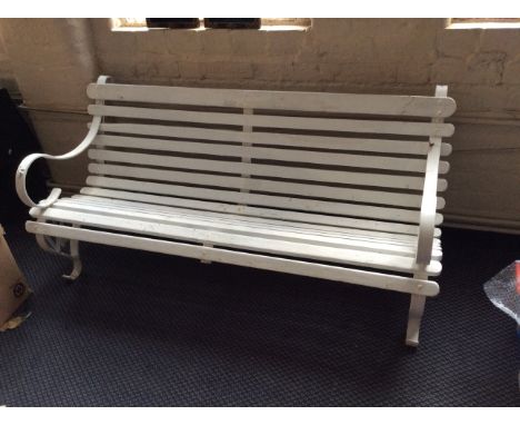 A white painted scroll arm garden bench.