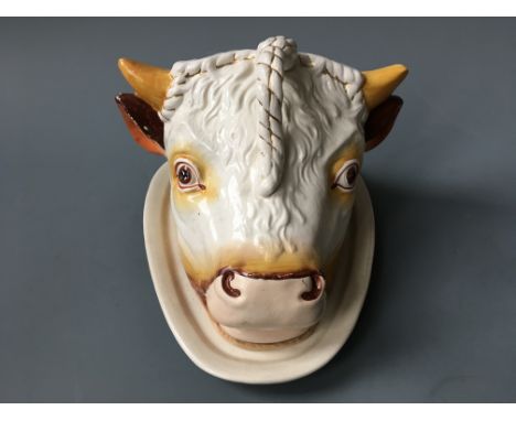 A Staffordshire cheese dish and cover in the form of a bulls head.