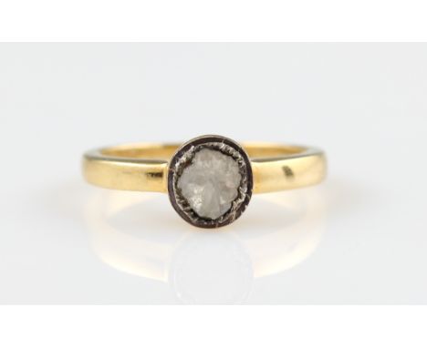 A diamond ring, set with a foil backed flat cut diamond, in unmarked yellow metal, ring size L½.