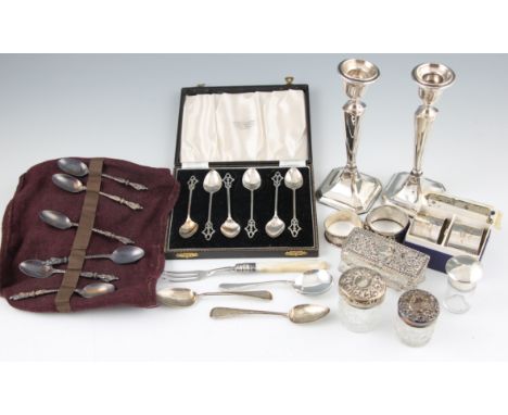 A collection of silverware to include Georgian teaspoons, along with Victorian and early 20th Century items, to include napki