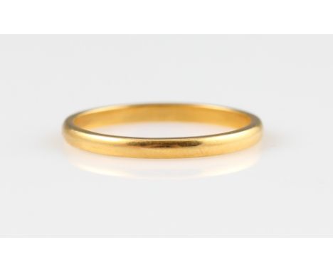 A wedding band, stamped 22ct, ring size R.