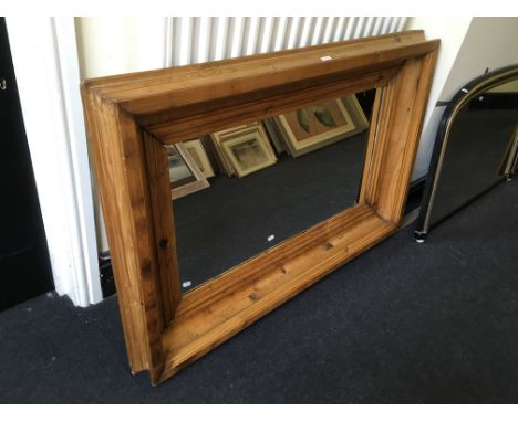 A pine framed mirror, 86cm x 126cm.