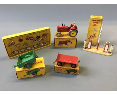 A Dinky 300 Massey Harris tractor, 341 Land-rover trailer, 429 trailer, 771 international road signs and 781 petrol pump stat