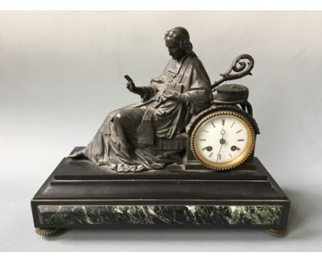 A mantel clock on marble base encased by bronze papal sculpture. Height 22cm.
