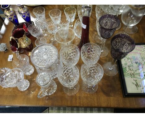 A collection of crystal cut drinking glasses, biscuit barrel, vases, coloured glassware etc.