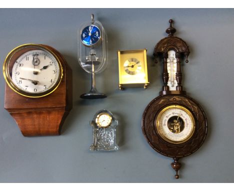 A mahogany cased barometer, hanging wall clock, Woodford mantel clock, timemaster and Waterford crystal cased clock.