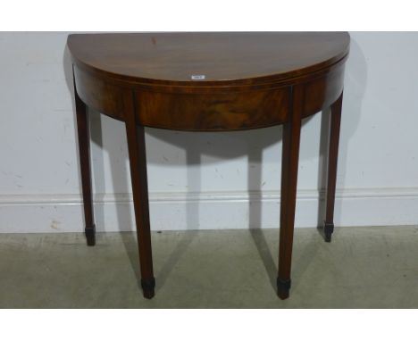 A 19th century mahogany demi lune tea table with fold over gate leg action, plain frieze on square tapering legs - 73cm x 82c