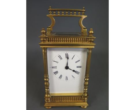 An early 20th century French brass carriage clock having ceramic dial with Roman numerals and minute track with poire hands, 