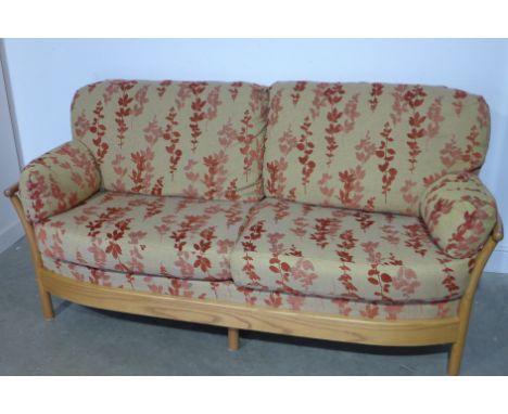 An Ercol ash framed Renaissance range three seater sofa with two matching armchairs with fabric upholstery complete with scat