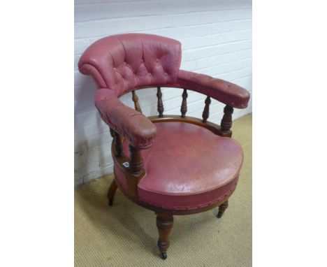 A Victorian walnut button leather upholstered Library chair with turned bobbin supports and turned front legs