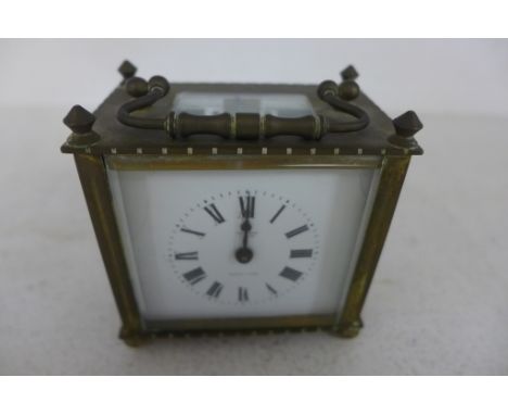 A brass cased five glass carriage clock, French - retailed by Selfridge and Company, white enamel dial with Roman numerals
Co