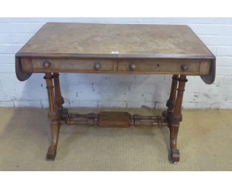 A Regency walnut sofa table with twin drop leaves, two frieze drawers on fluted supports and stretcher with castors - 73cm x 