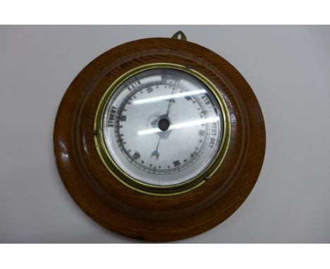 A circular ships barometer on a hardwood mount - 25cm diameter