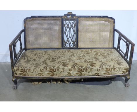 A 19th century lacquered Chinoise two seater sofa in the Chippendale style with rattan support with lattice work, fabric upho