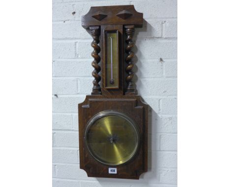 An early 20th century oak framed wall barometer with thermometer and brass circular dial and turned supports - 67cm x 28cm