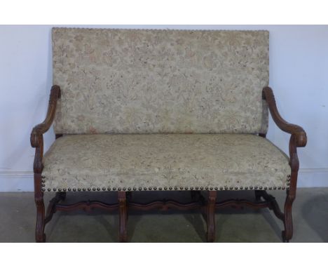 A 19th century walnut framed sofa with elaborate acanthus leaf carving to the arms, fabric upholstered with fluted decoration