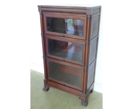 A Globe Wernicke style mahogany stacked bookcase with up and over glazed doors, turned supports on lion paw feet - 123cm x 67