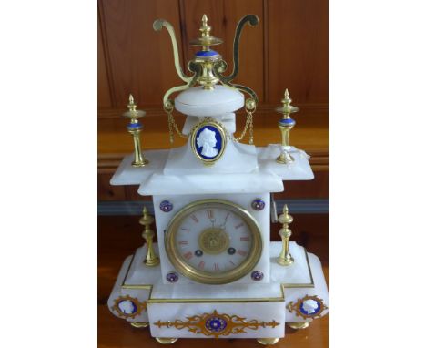 A 19th century French alabaster mantle clock with circular dial and Roman numerals with brass and porcelain fittings - 18cm x