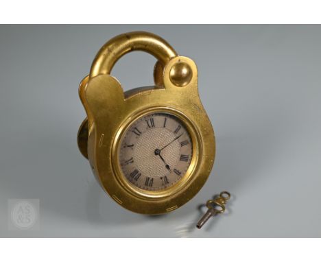 Howell James &amp; Co., London, a late Victorian novelty strut clock in the form of a padlock, the silvered engine turned dia